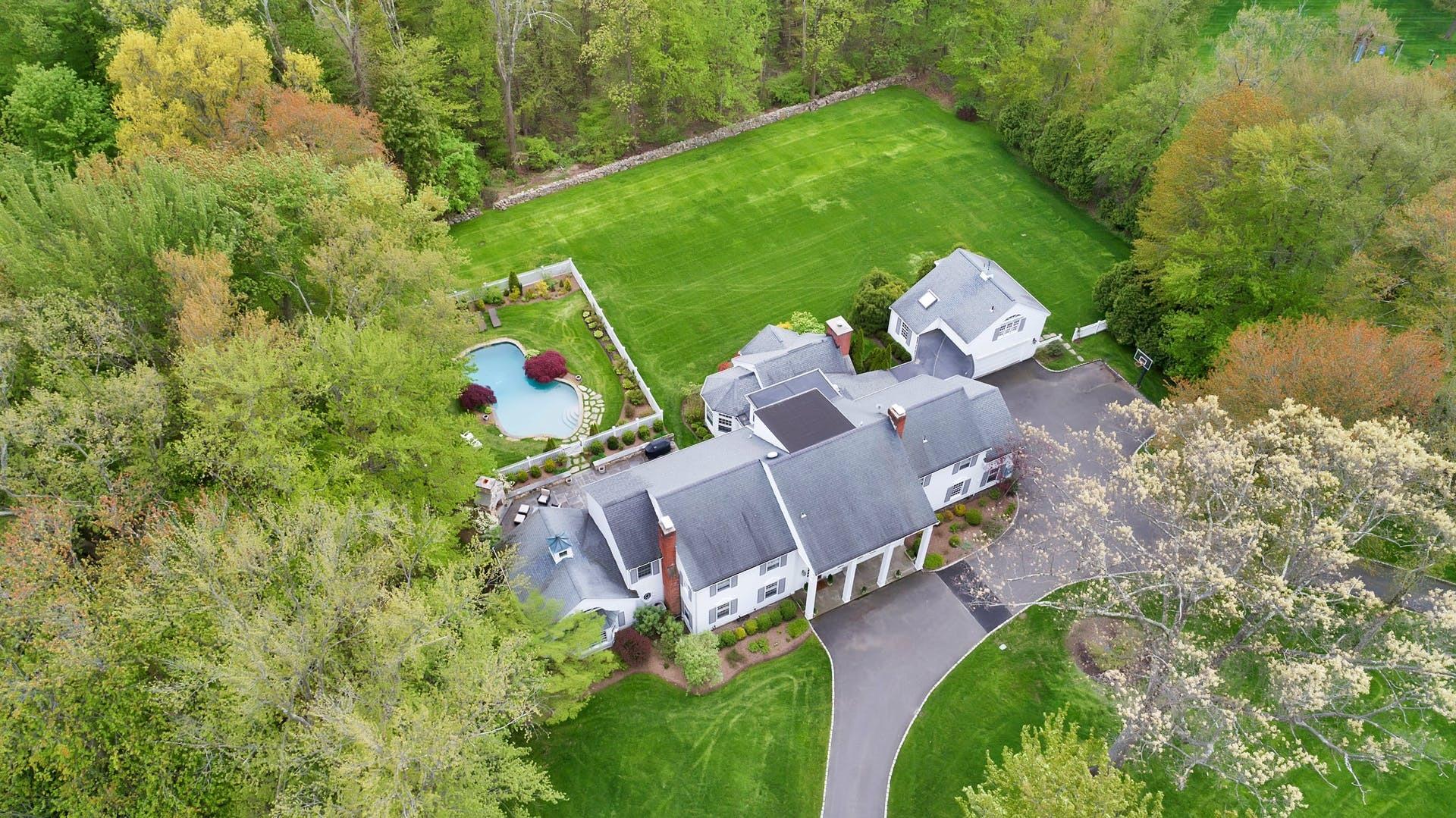 100 Stephen Mather Road Darien, CT 06820 - Photo 32 of 38 an aerial view of a house with a yard and lake view