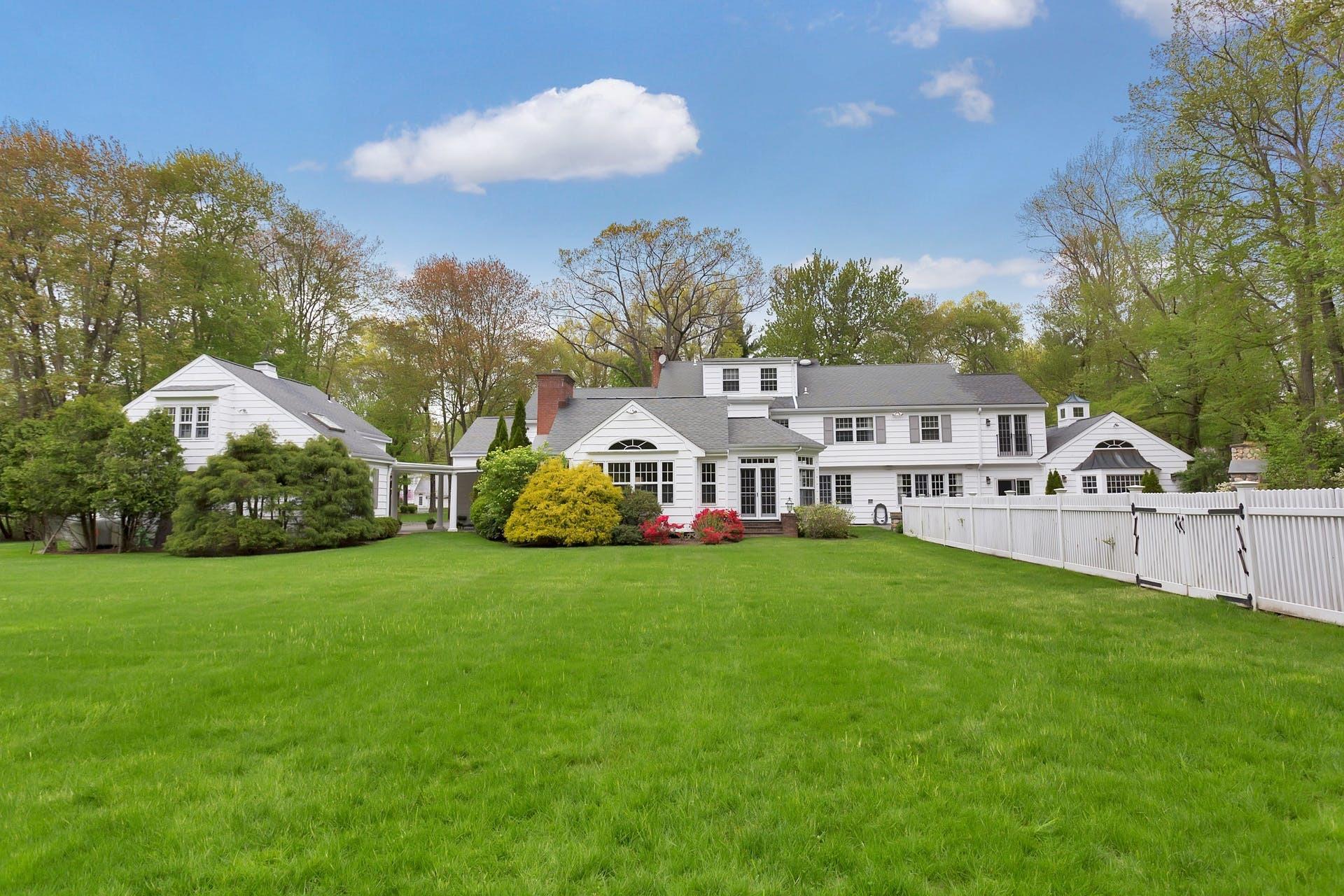 100 Stephen Mather Road Darien, CT 06820 - Photo 37 of 38 a front view of a house with a garden and yard