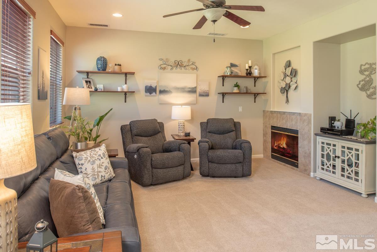 11225 Messina Way Reno, NV 89521 - Photo 7 of 40 a living room with furniture and a fireplace