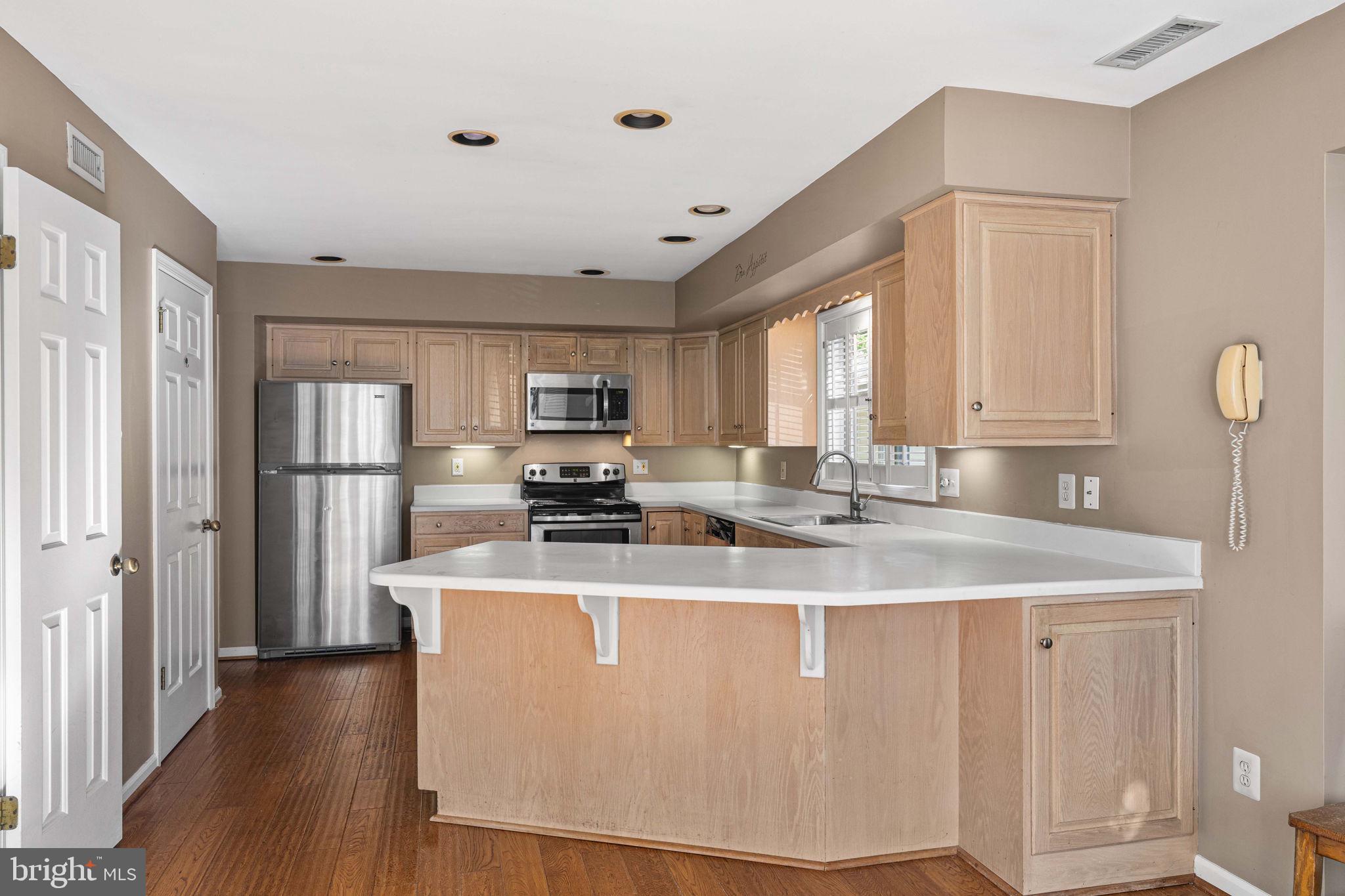 975 Kennett Way West Chester, PA 19380 - Photo 19 of 48 a kitchen with stainless steel appliances granite countertop a sink a refrigerator and a stove