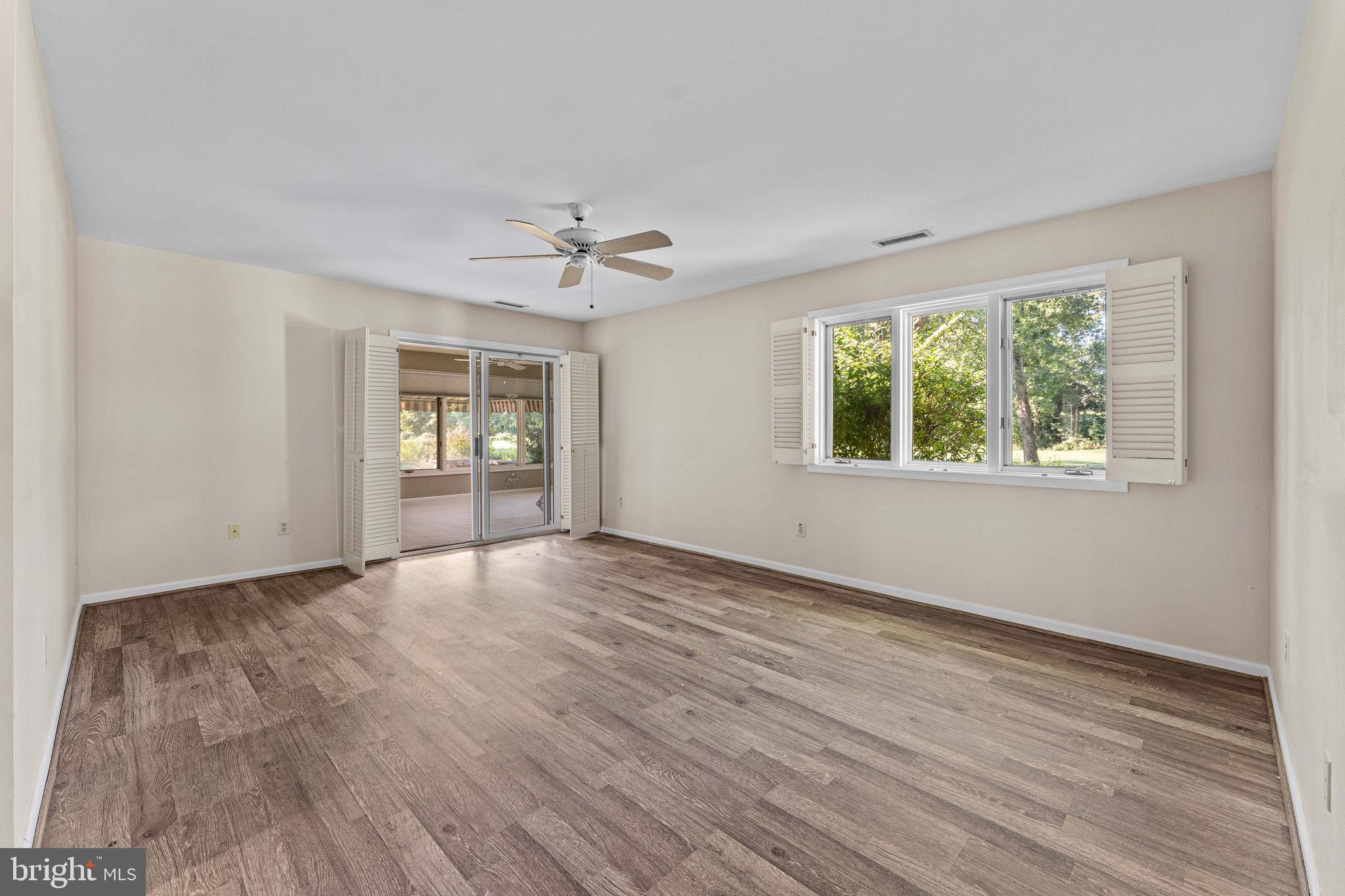 975 Kennett Way West Chester, PA 19380 - Photo 24 of 48 a view of an empty room with a window and wooden floor