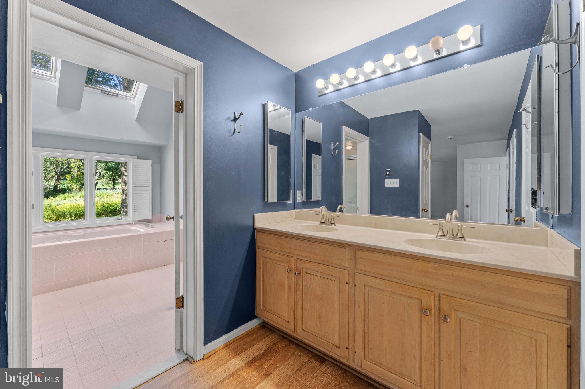 975 Kennett Way West Chester, PA 19380 - Photo 26 of 48 a spacious bathroom with a double vanity sink and a mirror