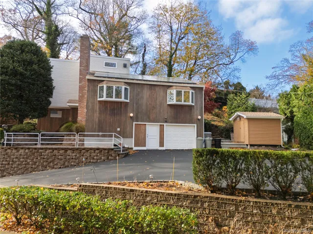 a front view of a house with a yard and a garage