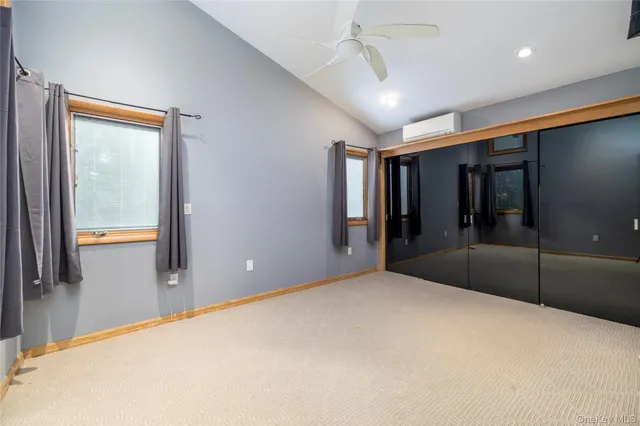 a big room with closet and windows