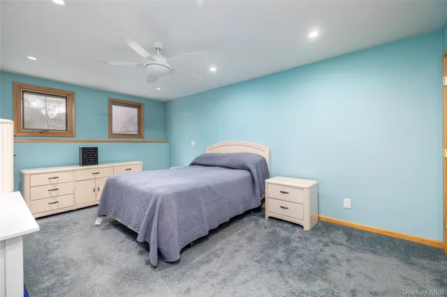 a spacious bedroom with a bed and a cabinets