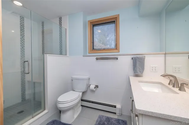a bathroom with a toilet sink and shower