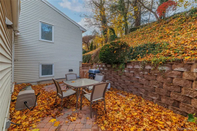 a backyard of a house with table and chairs