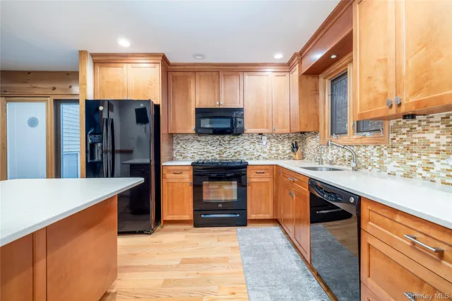 a kitchen with stainless steel appliances granite countertop wooden cabinets a sink and a stove