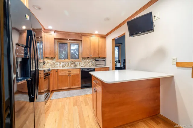 a kitchen with stainless steel appliances kitchen island granite countertop a sink stove and refrigerator
