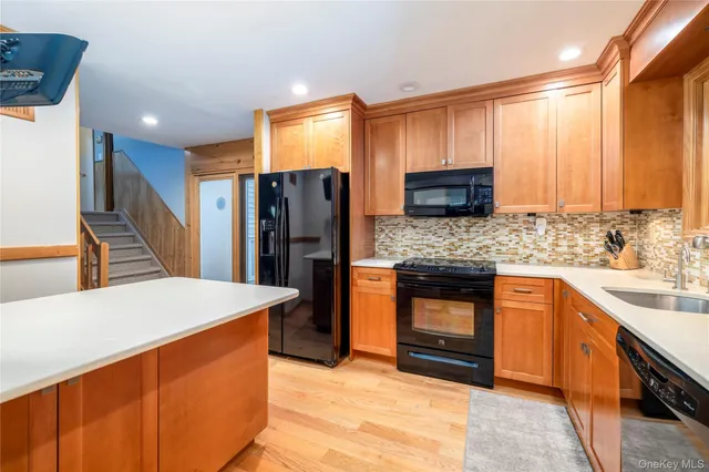 a kitchen with stainless steel appliances kitchen island granite countertop a refrigerator and a stove top oven