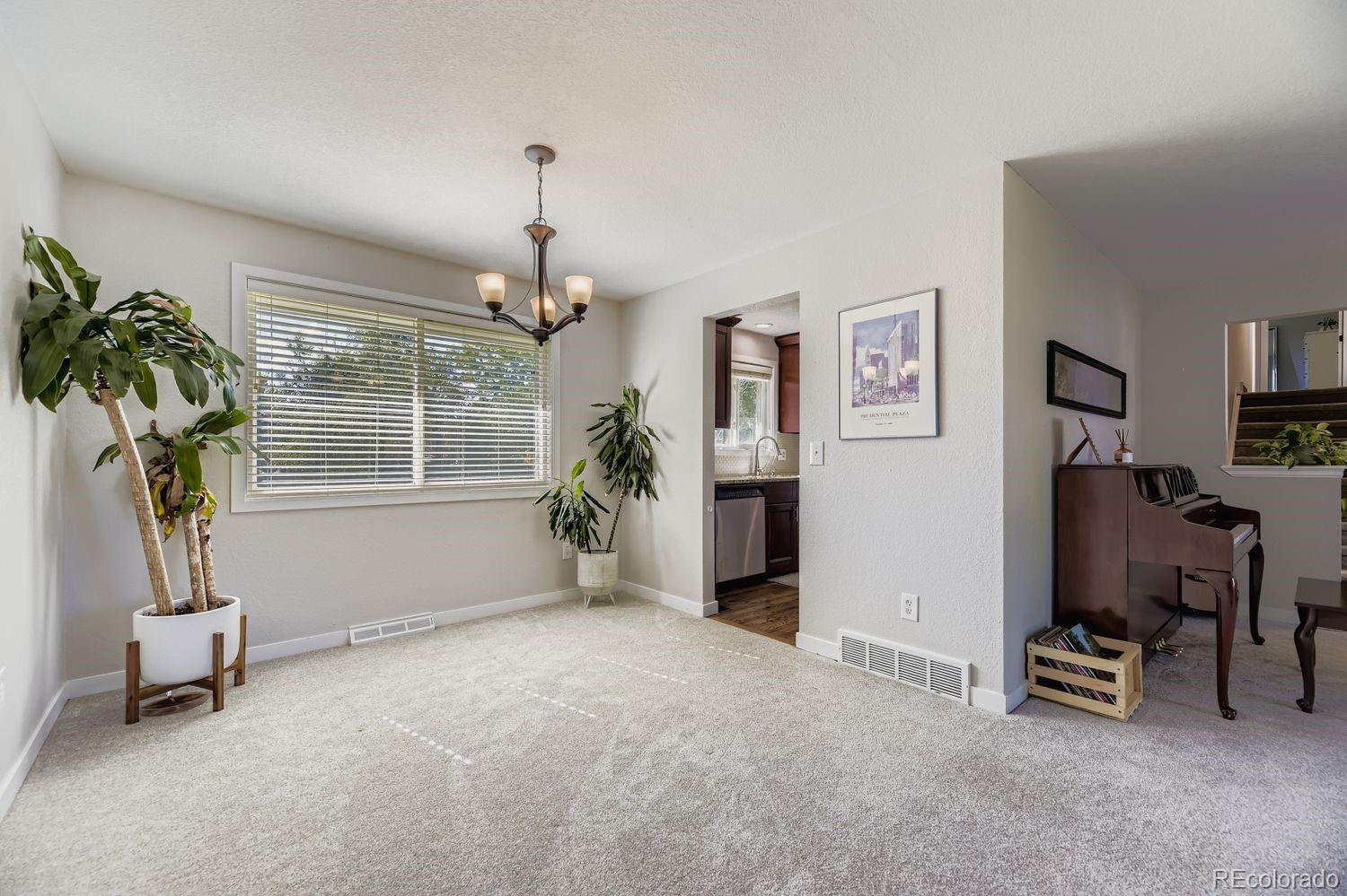 7161 South Franklin Street Centennial, CO 80122 - Photo 12 of 28 a living room with furniture and a flat screen tv