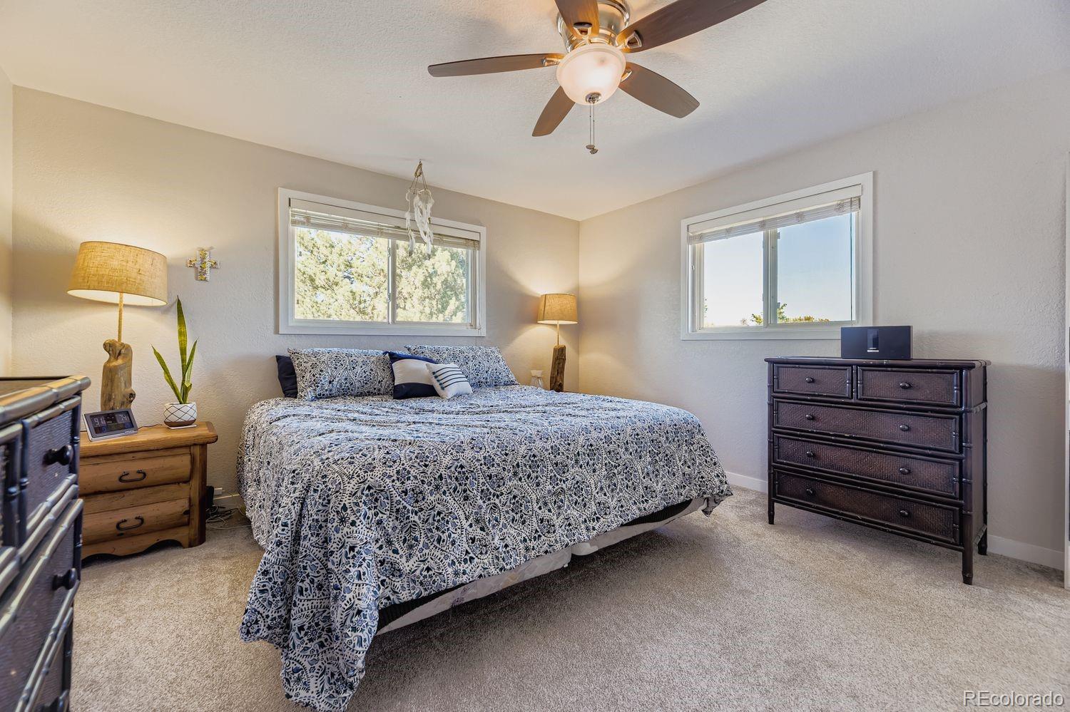 7161 South Franklin Street Centennial, CO 80122 - Photo 14 of 28 a bedroom with a bed and a chandelier