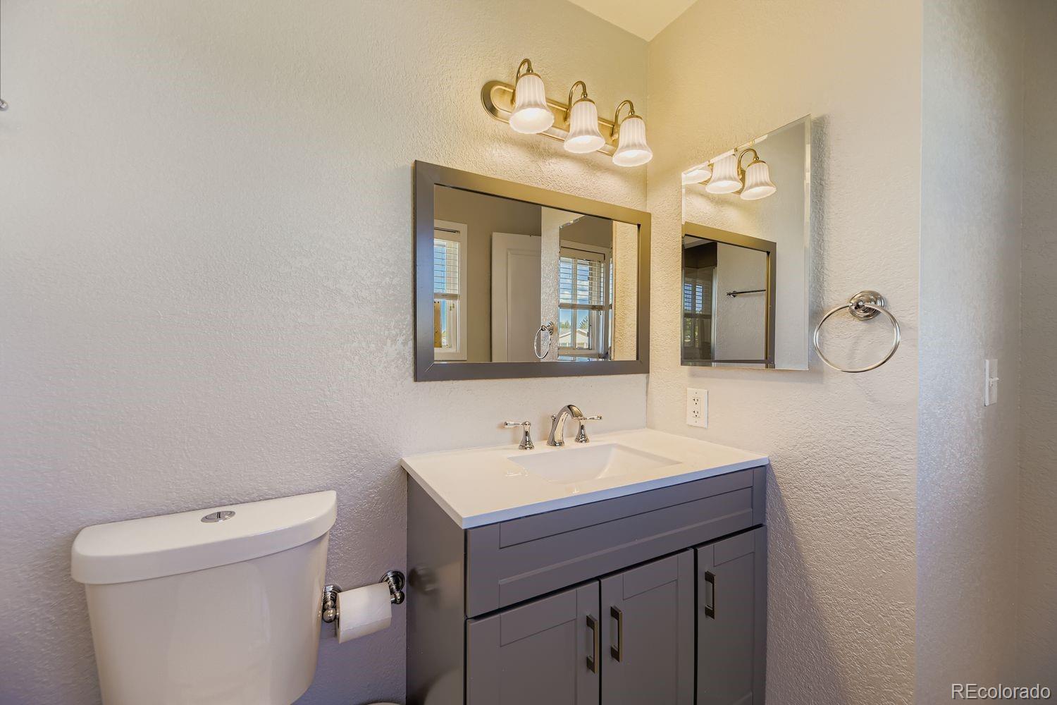 7161 South Franklin Street Centennial, CO 80122 - Photo 17 of 28 a bathroom with a sink a toilet and mirror