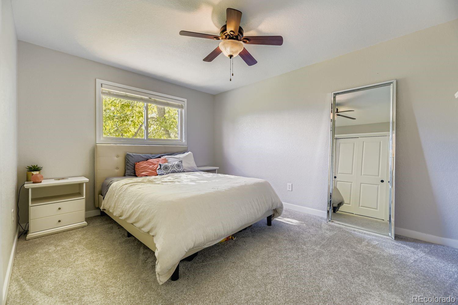 7161 South Franklin Street Centennial, CO 80122 - Photo 19 of 28 a bedroom with a bed and a chandelier