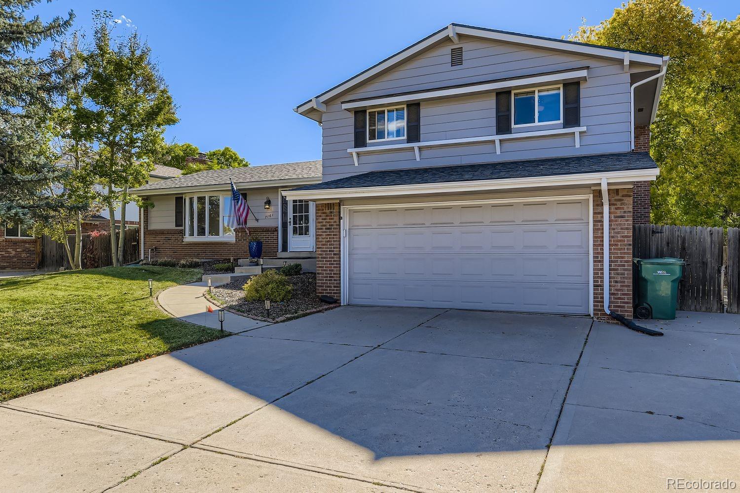 7161 South Franklin Street Centennial, CO 80122 - Photo 2 of 28 a front view of a house with a yard