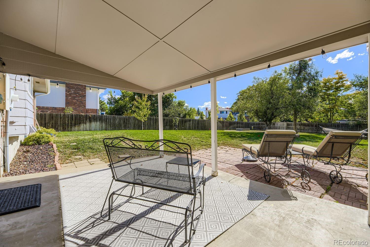 7161 South Franklin Street Centennial, CO 80122 - Photo 24 of 28 a view of a patio with a table chairs and a yard