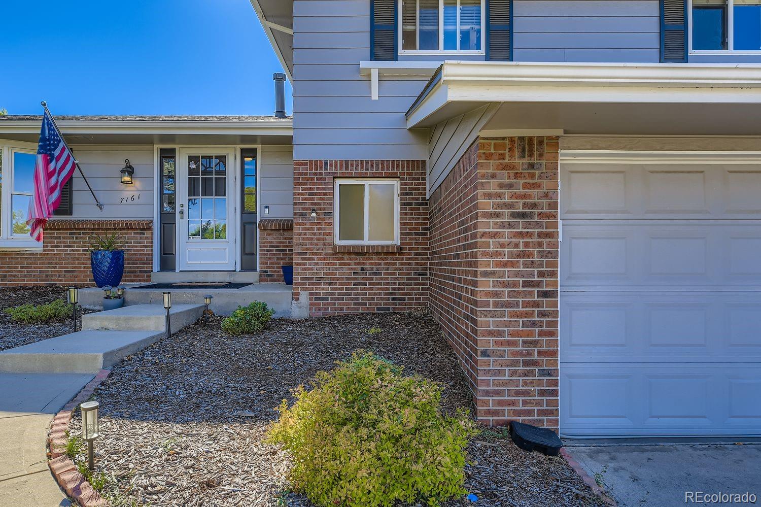 7161 South Franklin Street Centennial, CO 80122 - Photo 3 of 28 a front view of a house with garden