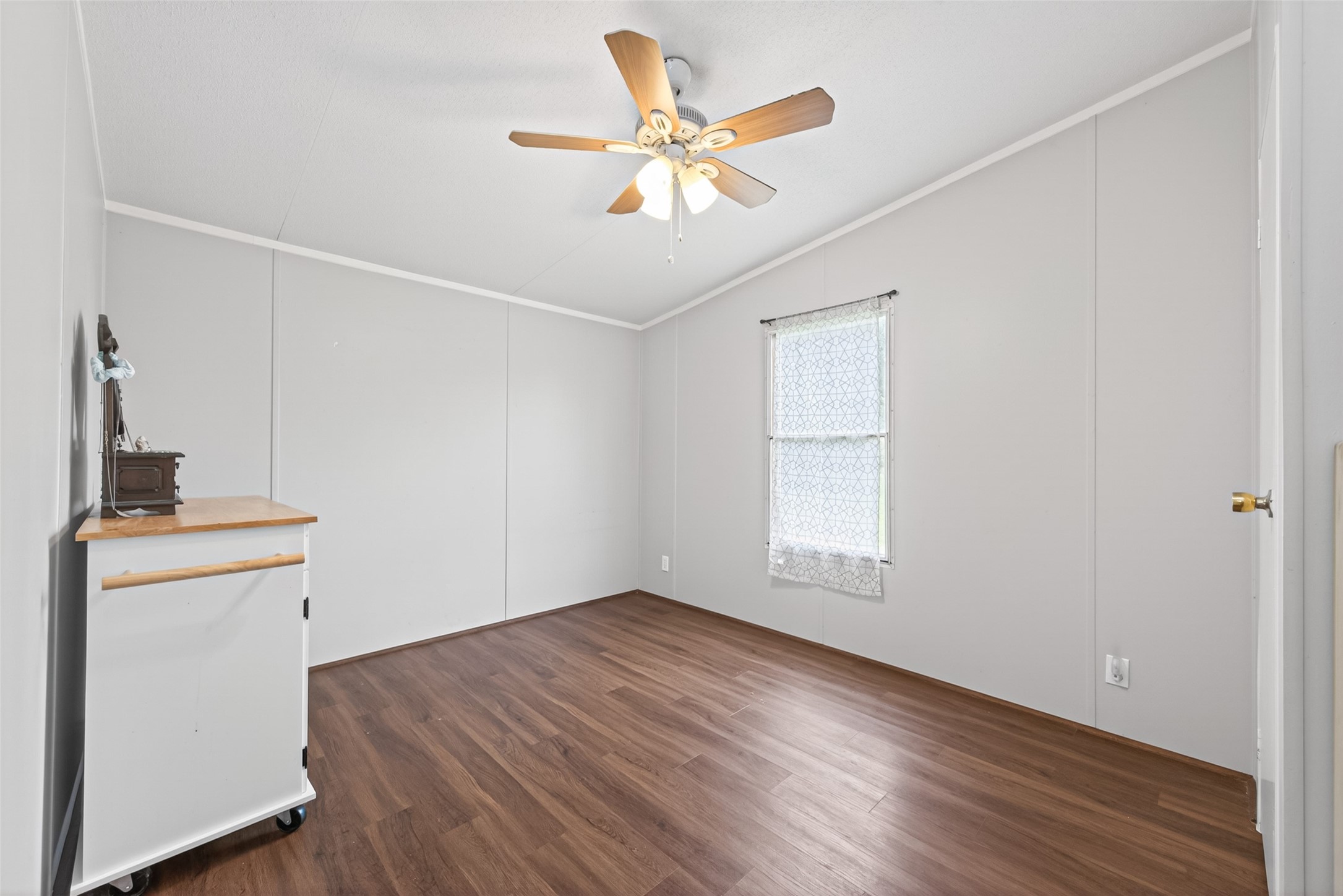 16572 River Ranch Drive Conroe, TX 77302 - Photo 10 of 18 an empty room with wooden floor and ceiling fan