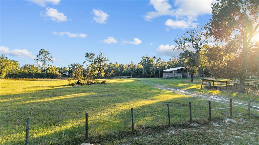 13200 Southwest 95th Street Dunnellon, FL 34432 - Photo 12 of 23 a view of a swimming pool with an outdoor space and seating area