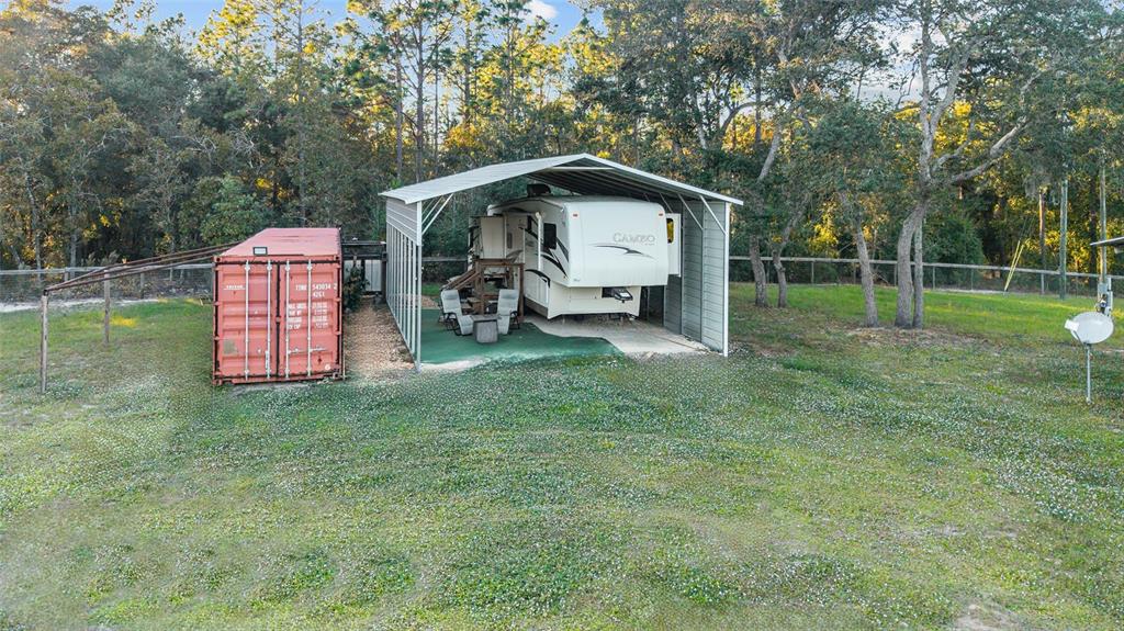 13200 Southwest 95th Street Dunnellon, FL 34432 - Photo 9 of 23 a backyard of a house with childrens swings and slides