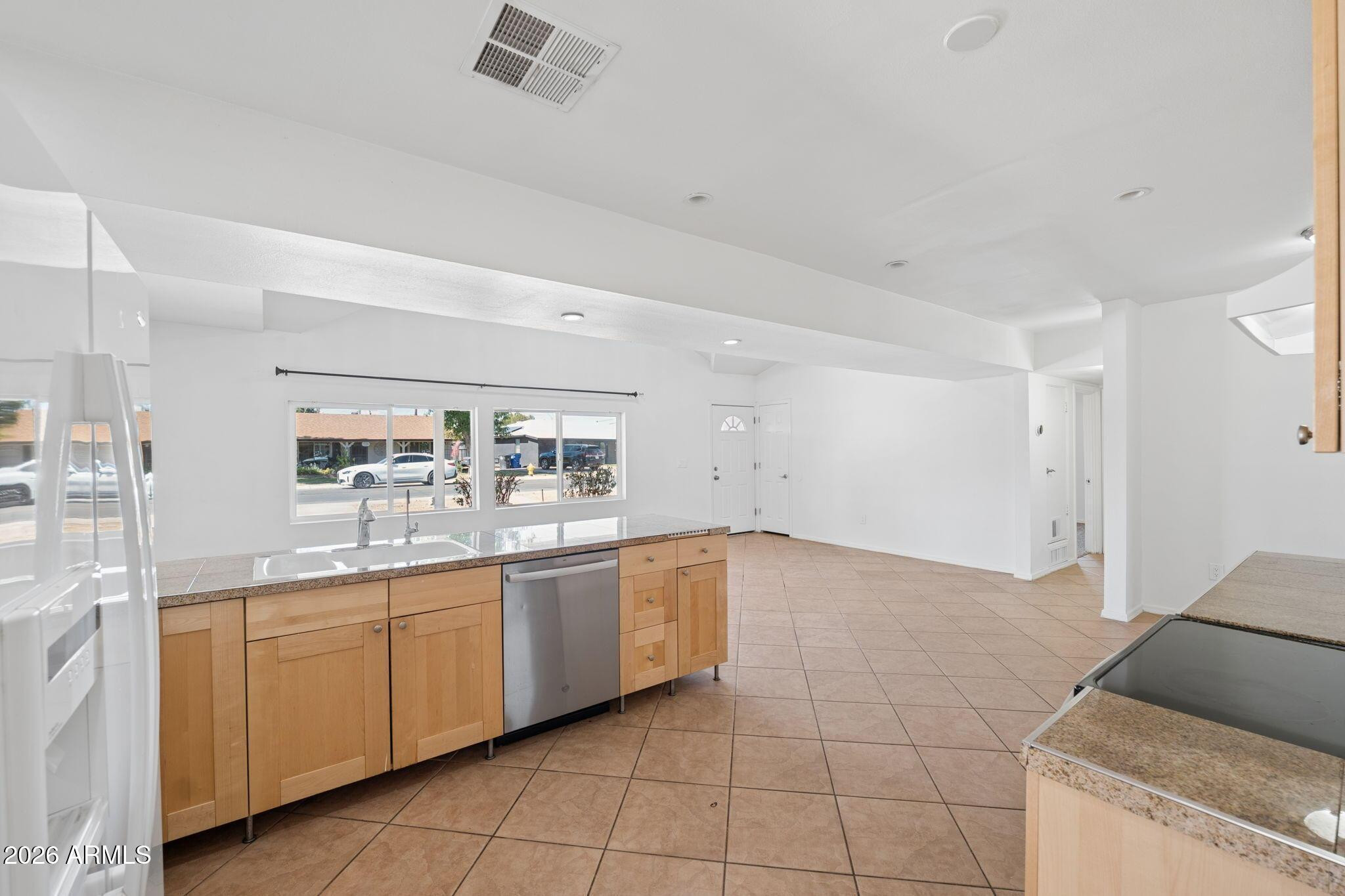 7 South Catalina Street Gilbert, AZ 85233 - Photo 9 of 34 a large white kitchen with a sink and dishwasher with a large window