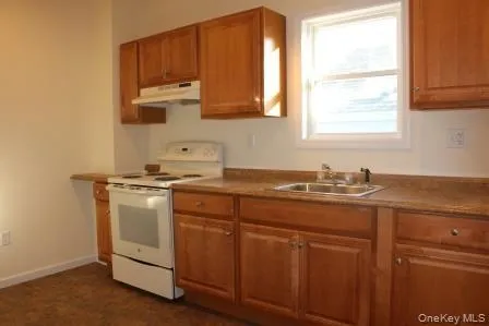 a kitchen with sink cabinets and window