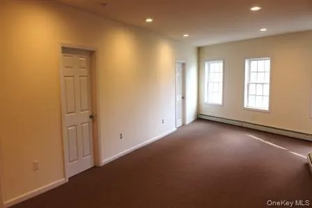 an empty room with windows and closet