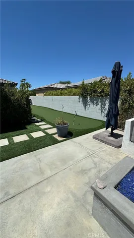 a view of a garden with a building in the background