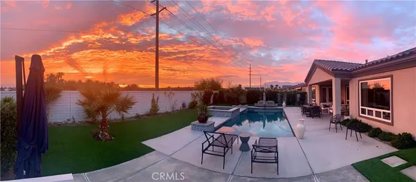 a view of a patio with couches fire pit and chairs