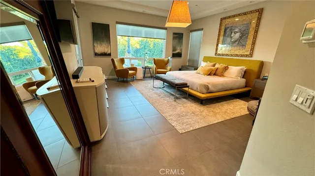 a bedroom with furniture and a large window