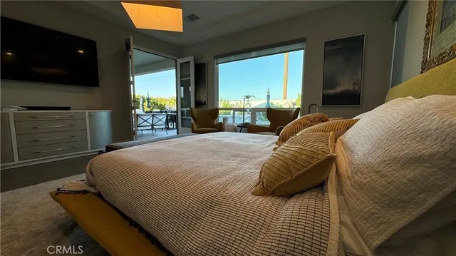 a bed sitting in a bedroom next to a window