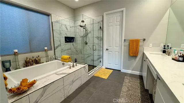 a bathroom with a tub sink and mirror