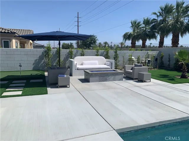 a view of a patio with couches and potted plants