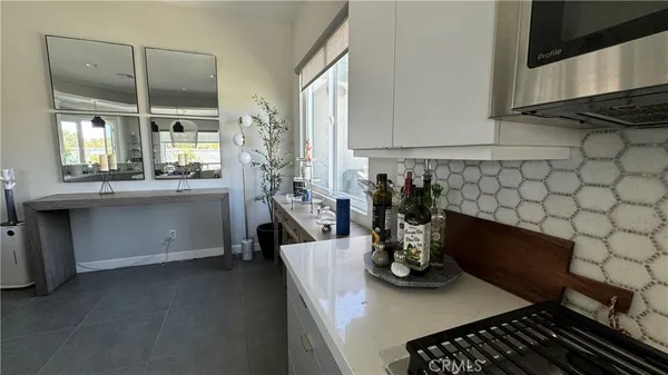 a kitchen with a sink and a stove top oven