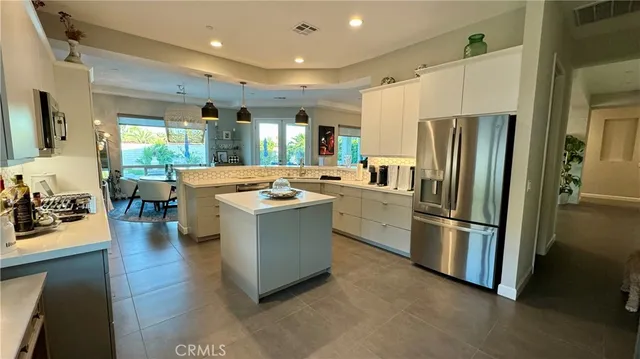 a kitchen with refrigerator and cabinets