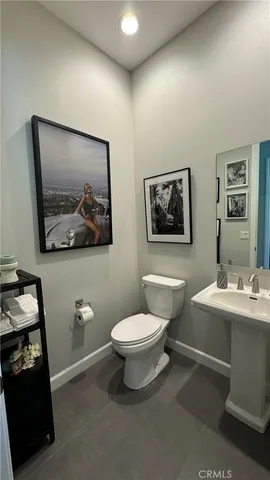 a bathroom with a toilet a sink and a mirror