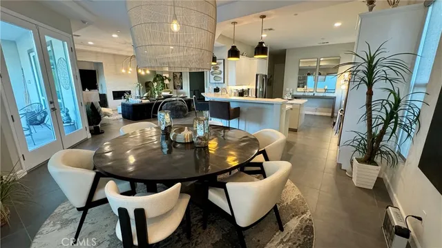 a dining room with furniture and wooden floor