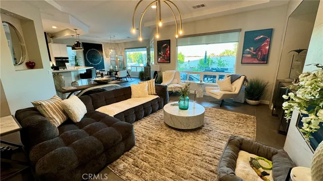 a living room with furniture potted plant and a large window