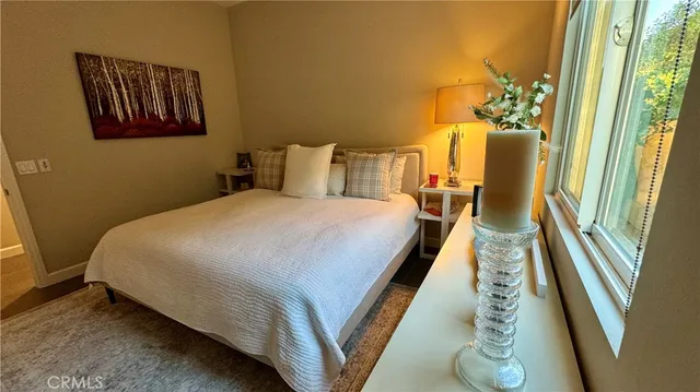 a bedroom with a bed and a mirror