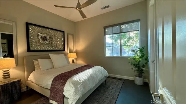 a bedroom with a bed and a painting on the wall