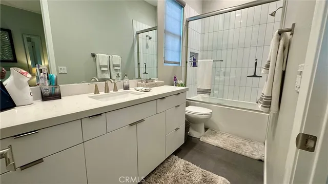 a bathroom with a double vanity sink toilet and shower