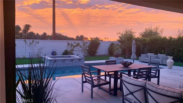 a view of a chairs and table in patio