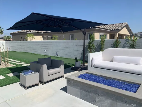 a view of a patio with couches chairs and a table