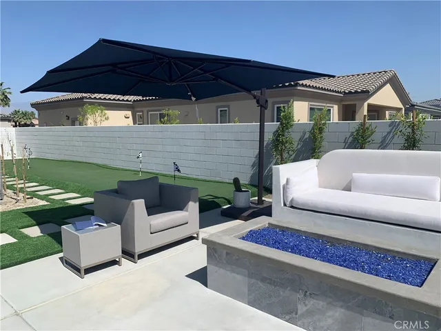 a view of a patio with couches chairs and a table