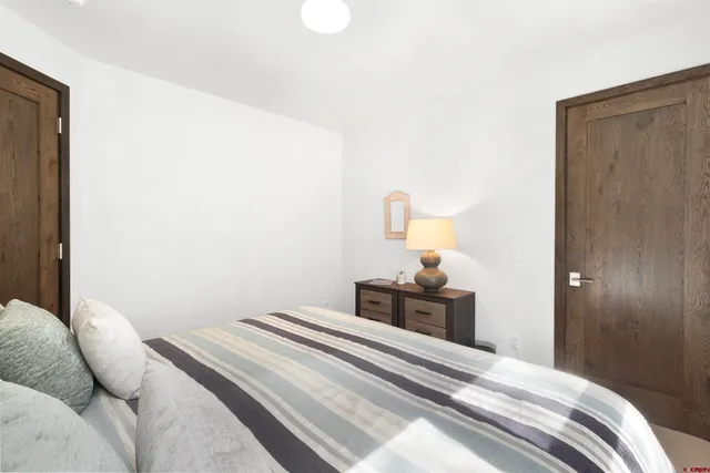 a bedroom with a bed and a lamp