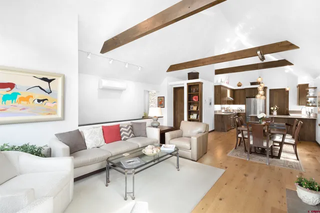 a living room with furniture and view of kitchen
