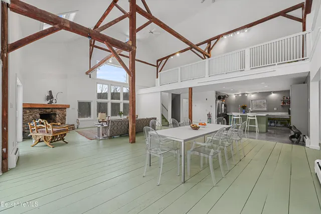 a view of a dining room with furniture a chandelier and wooden floor