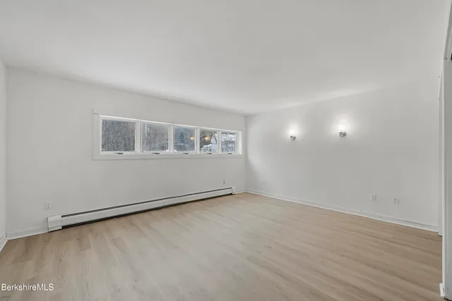 a bathroom with a granite countertop shower and a sink