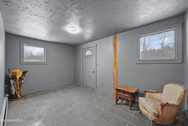 a view of a livingroom with furniture and a window