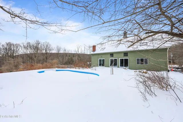 a view of a house covered in snow